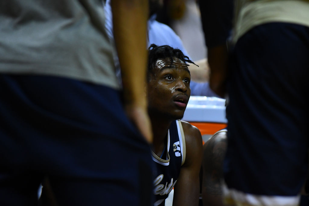 Charleston Southern player Phlandrous Fleming listens to his coach during a time out in the game